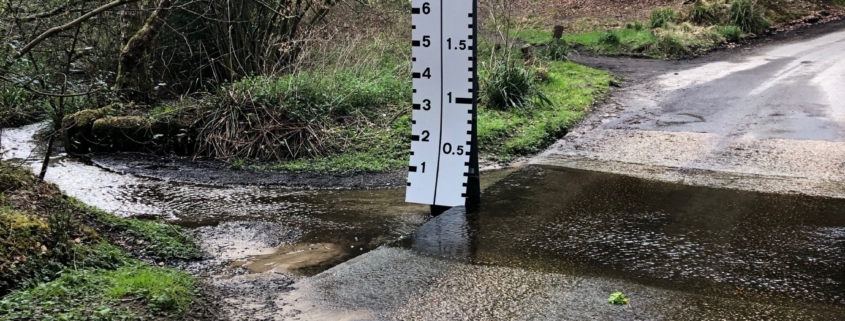 Water measure sign next to a ford crossing